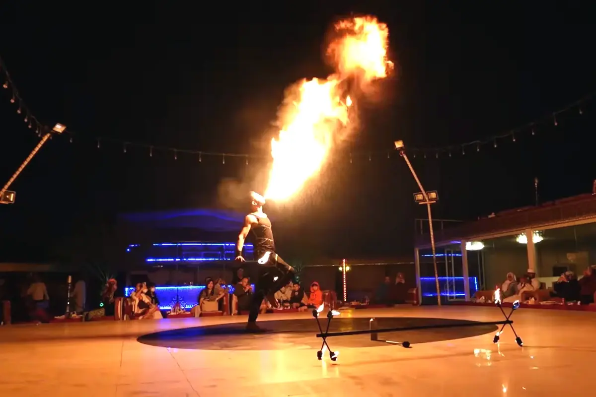 Man performing fire show at desert safari dubai camp