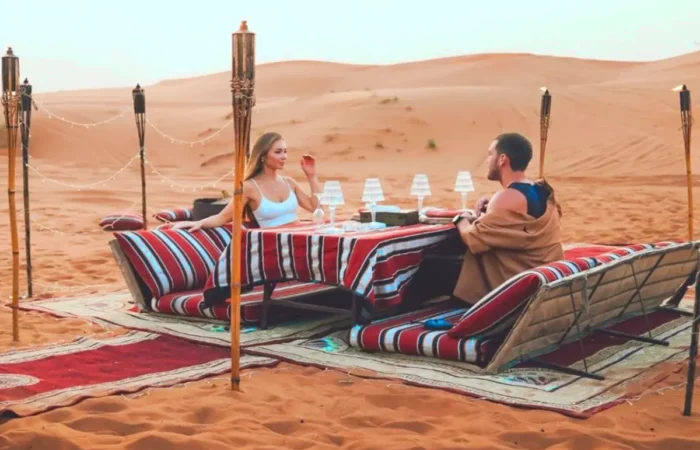 man and woman sitting at table in private desert safari dubai tour