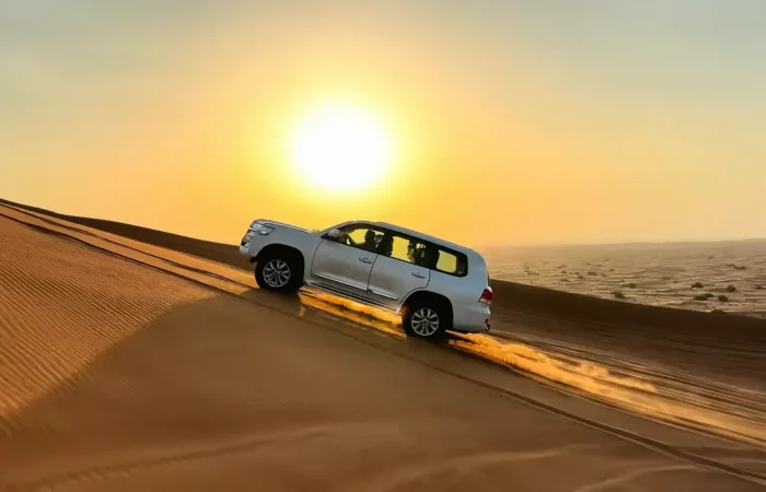 Landcruiser roaring up on hill at sunset