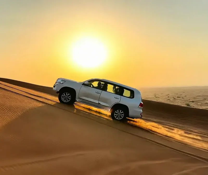 Landcruiser roaring up on hill at sunset