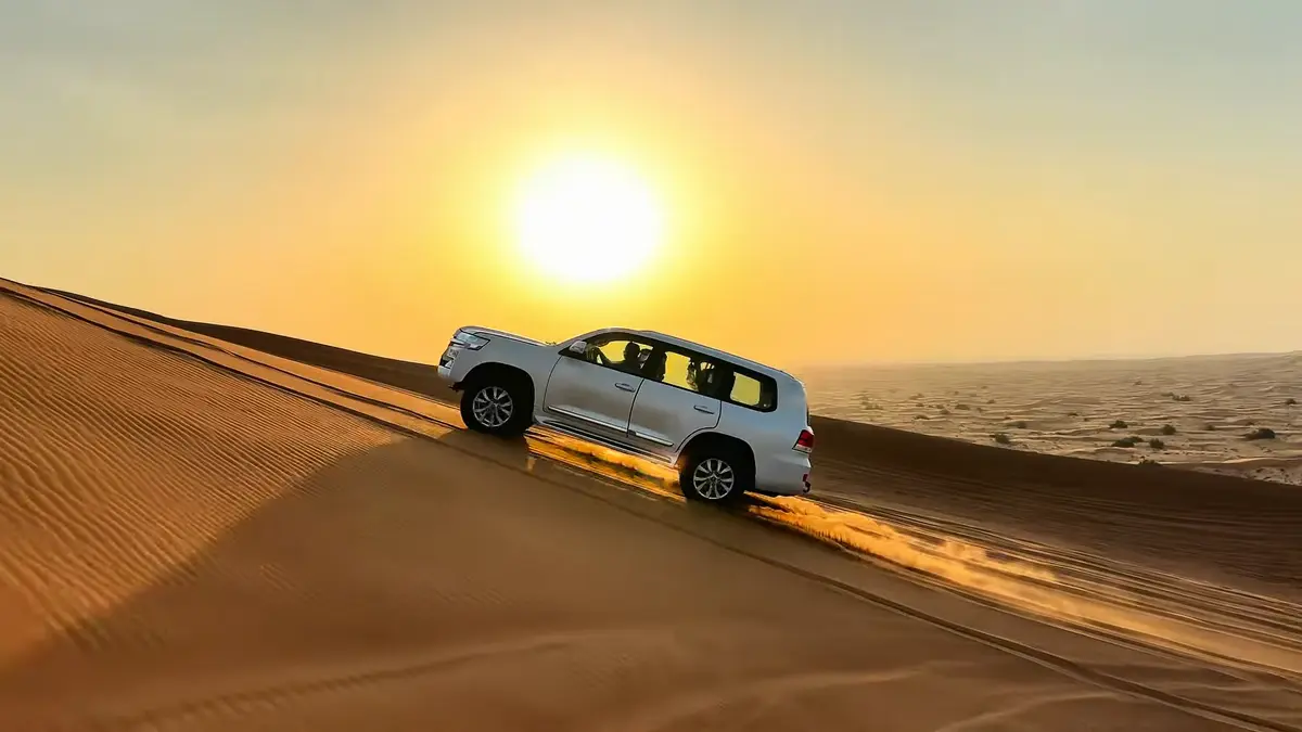 Landcruiser roaring up on hill at sunset