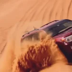 Landcruiser roaring up on hill in Dubai desert